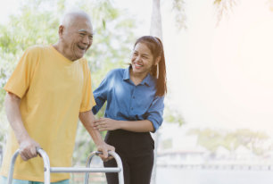 an adult woman taking care of an elderly man