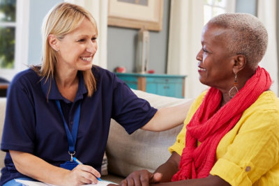 old woman and nurse talking