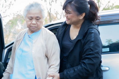 Nurse aid assisting elderly woman