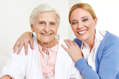 old woman and doctor smile together