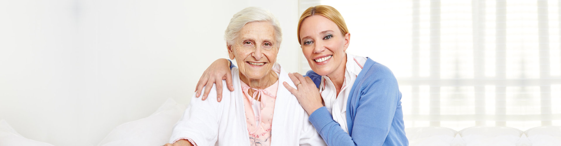 old woman and doctor smile together