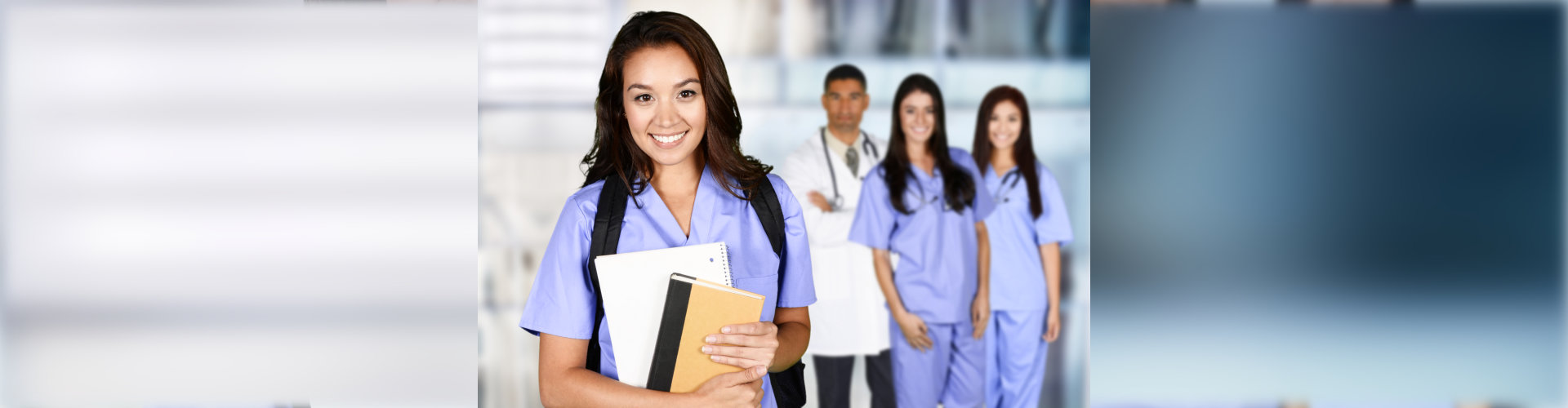 nurse holding folders with other nurses in background